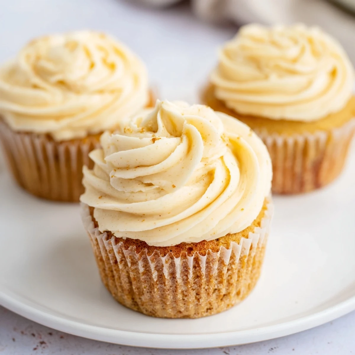 Fluffy, homemade vanilla cupcakes with creamy, swirled buttercream frosting; a dessert dream.