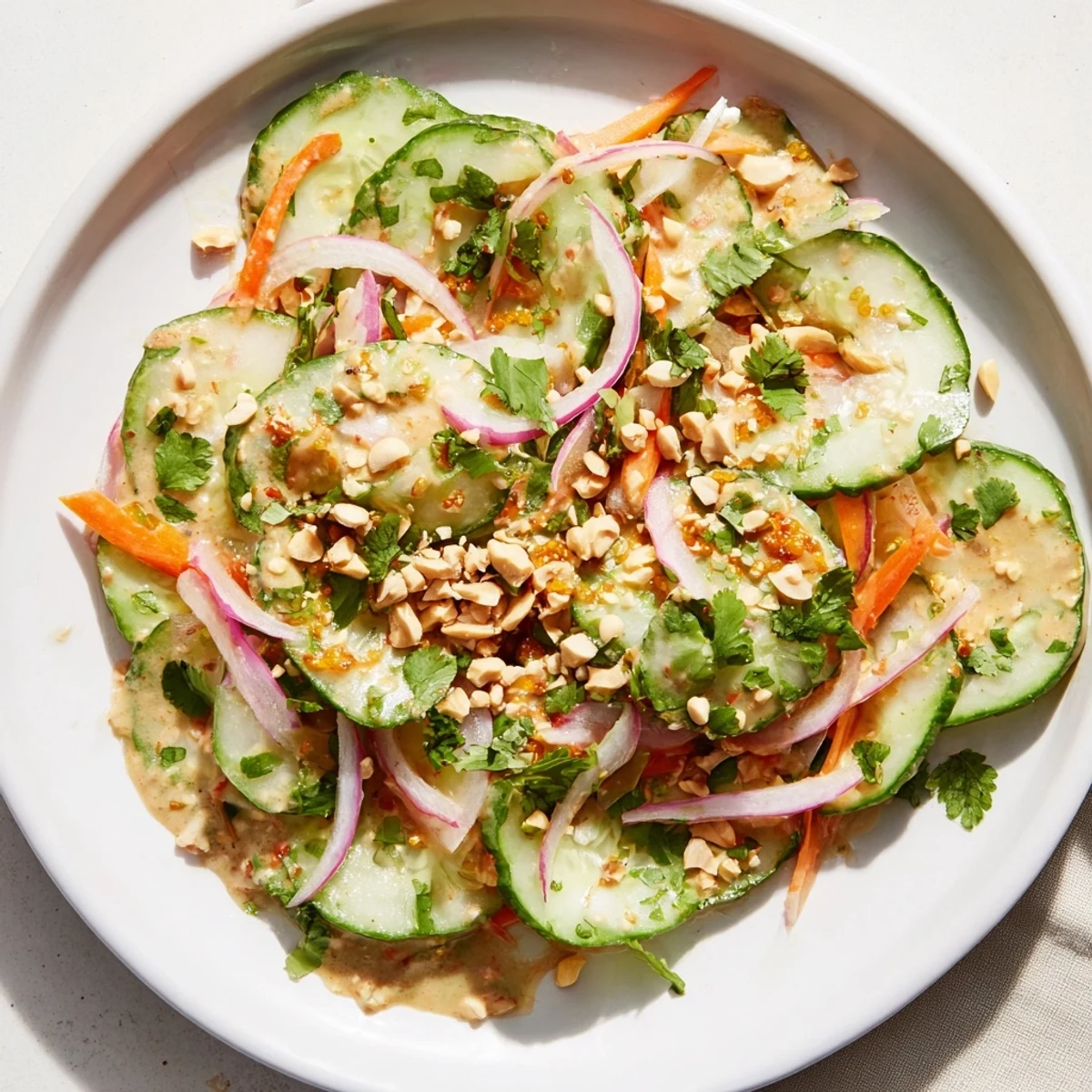 Fresh Thai-Style Peanut Cucumber Salad, with vibrant greens and a creamy peanut dressing.