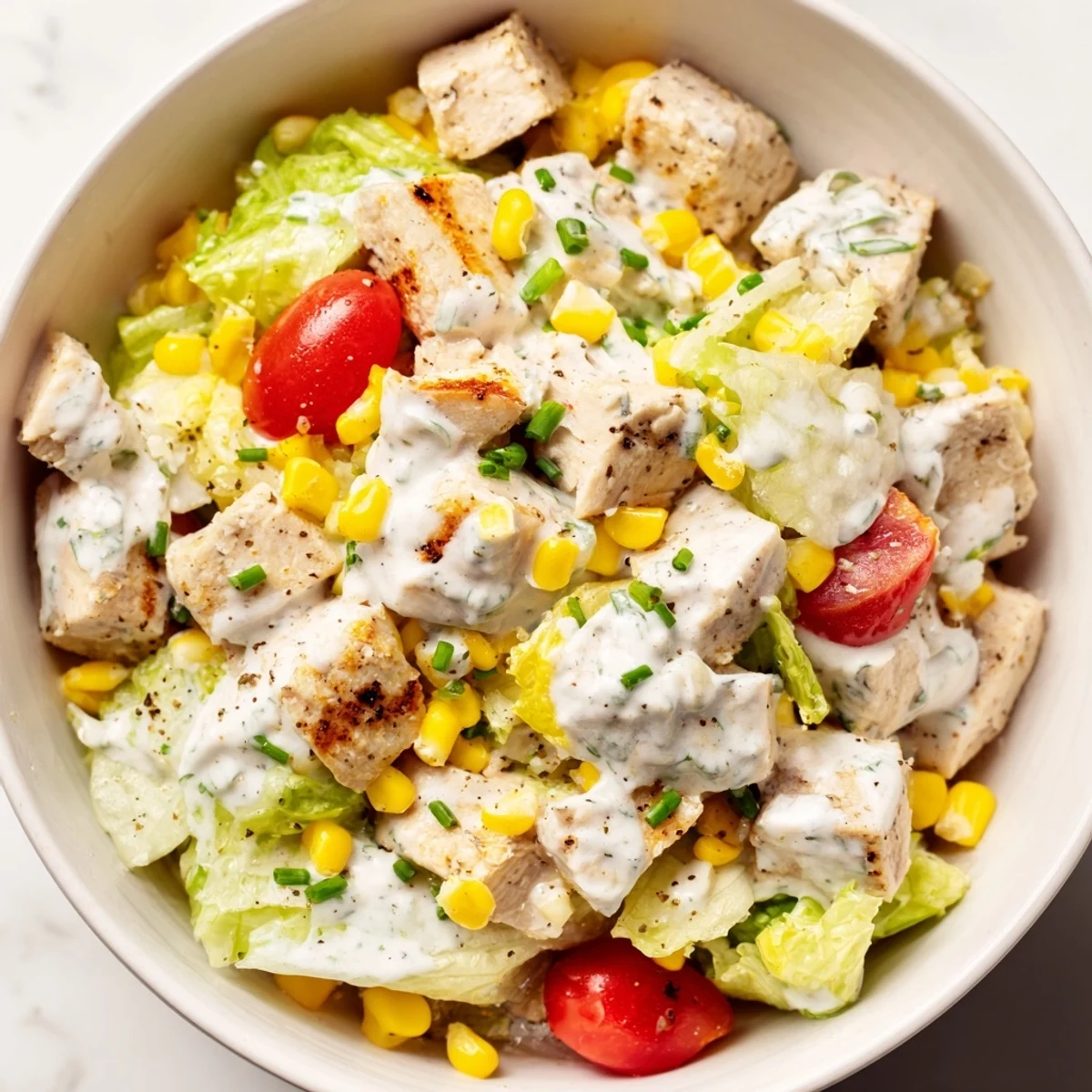 Overhead view of Ranch Chicken Chopped Salad with diced cucumbers, tomatoes, and creamy Greek yogurt ranch dressing.  