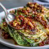 Warm Baked Cabbage Salad With Winter Romesco served on a rustic platter.