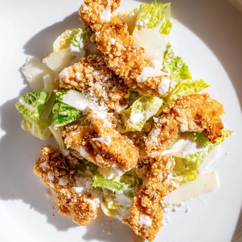 Freshly fried chicken pieces nestled in a soft flour tortilla with Caesar dressing, ready for a quick and flavorful lunch.