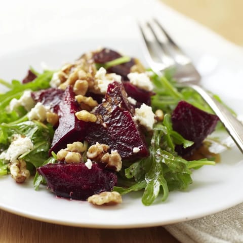Warm toasted walnuts add a satisfying crunch to the colorful Roasted Beet Goat Cheese Salad, drizzled with bright balsamic vinaigrette.