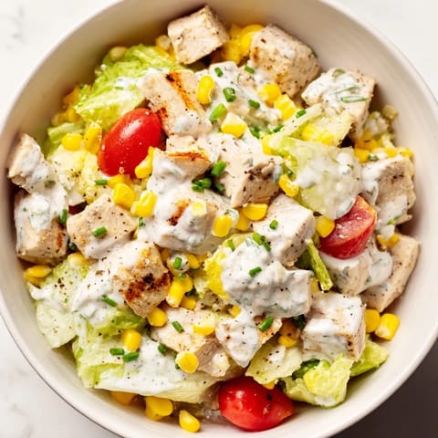 Overhead view of Ranch Chicken Chopped Salad with diced cucumbers, tomatoes, and creamy Greek yogurt ranch dressing.  