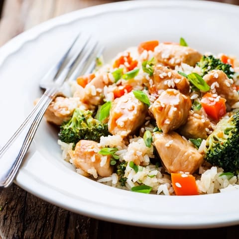 Golden-brown chicken pieces, fluffy rice, and vibrant broccoli florets glisten with a sweet honey garlic sauce in this One Pan Honey Garlic Chicken Broccoli Rice dish.