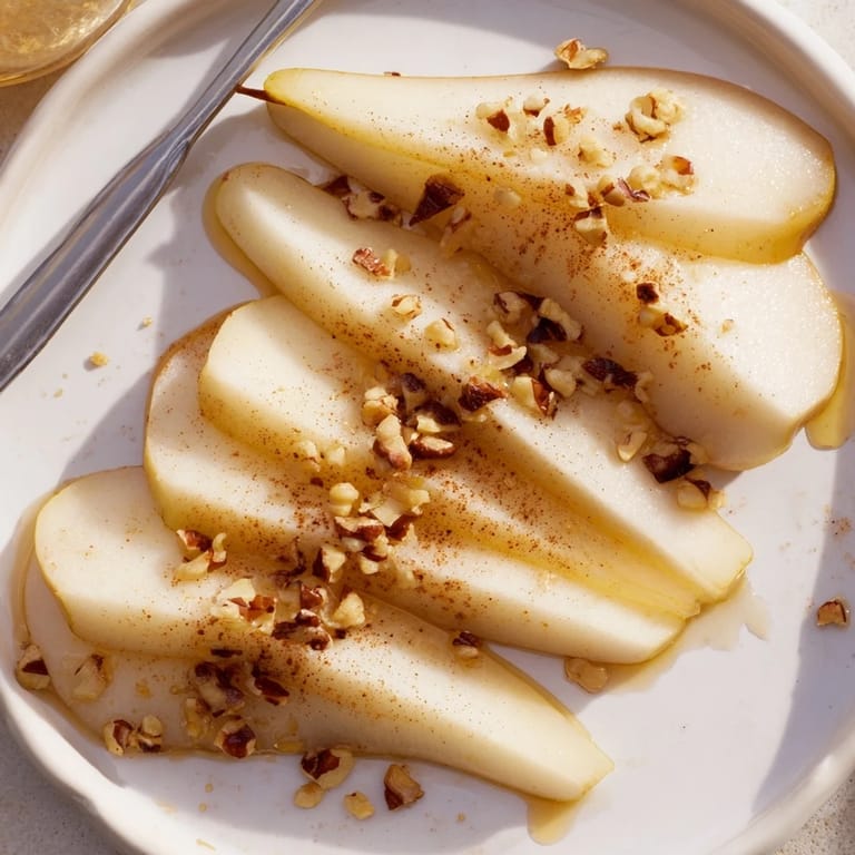 Elegant serving of pear slices with honey and a sprinkle of cinnamon for added flavor.