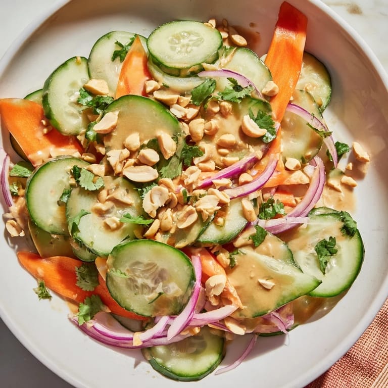 This colorful Thai-Style Peanut Cucumber Salad features crisp cucumbers and peanuts, ready to enjoy.